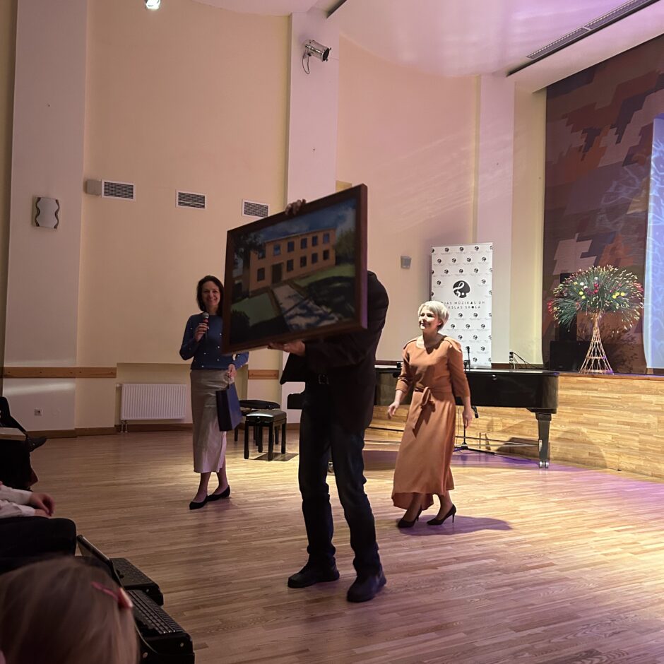 Liepājas pilsētas 2. mūzikas skola saņem dāvanu - gleznu, kurā attēlota skola.